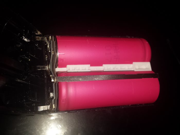 NP-FM500H Lithium Battery Cracked Open with exposed SANYO cells